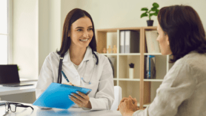 British expat couple consulting an English-speaking doctor in a Marbella private clinic.