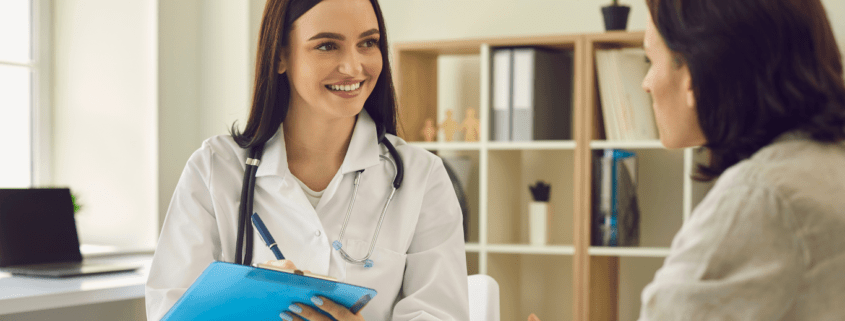 British expat couple consulting an English-speaking doctor in a Marbella private clinic.