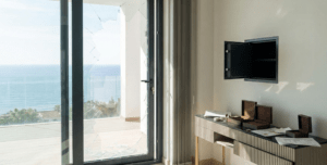 Smashed glass door and empty safe after a burglary in a luxury Costa del Sol apartment, highlighting the need for private contents insurance.