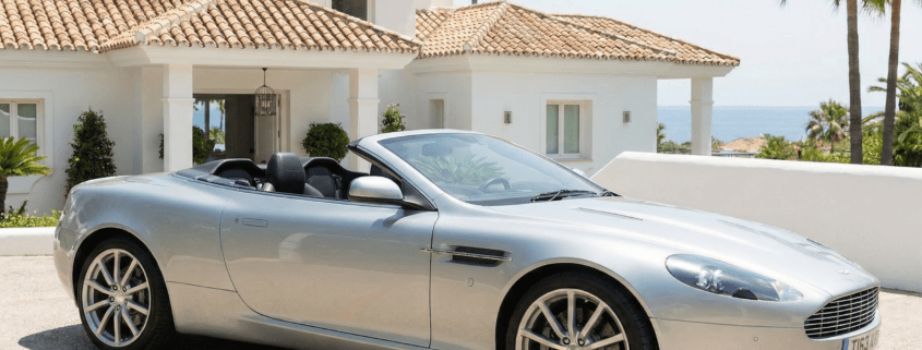 British expat standing next to a luxury car after securing premium car insurance in Marbella