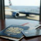 Passport and boarding pass on a lounge table representing annual multi-trip insurance for frequent flyers in Malaga.