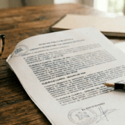 Spanish mortgage contract with life insurance clauses on a desk.