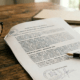 Spanish mortgage contract with life insurance clauses on a desk.