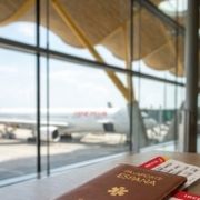 Passport and boarding passes ready for an expat international trip from Spain.