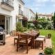 Modern gas barbecue and wooden patio furniture in a Spanish garden