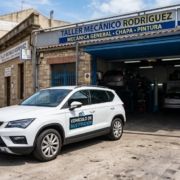 White courtesy car parked outside a local Spanish mechanic garage.