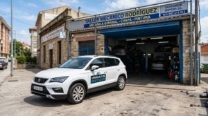 White courtesy car parked outside a local Spanish mechanic garage.